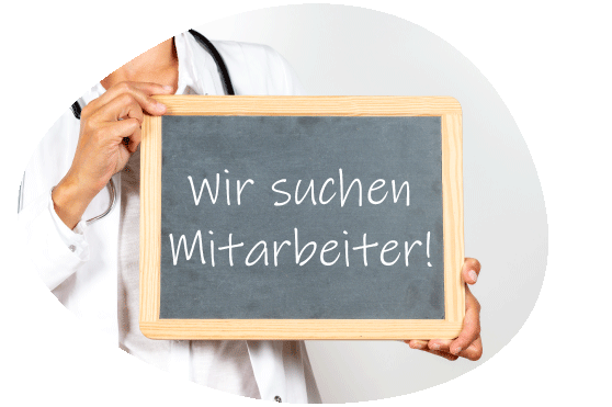 Das Bild Zeigt einen Artzt mit Stetoskop, der ein Schild hält, auf dem Wir suchen Mitarbeiter steht, was gerade Thema in der Praxis Tributh der Hausärtzinnen am Volkspark in Potsdam Nord in Bornstedt nahe der Fachhochschule Potsdam ist.